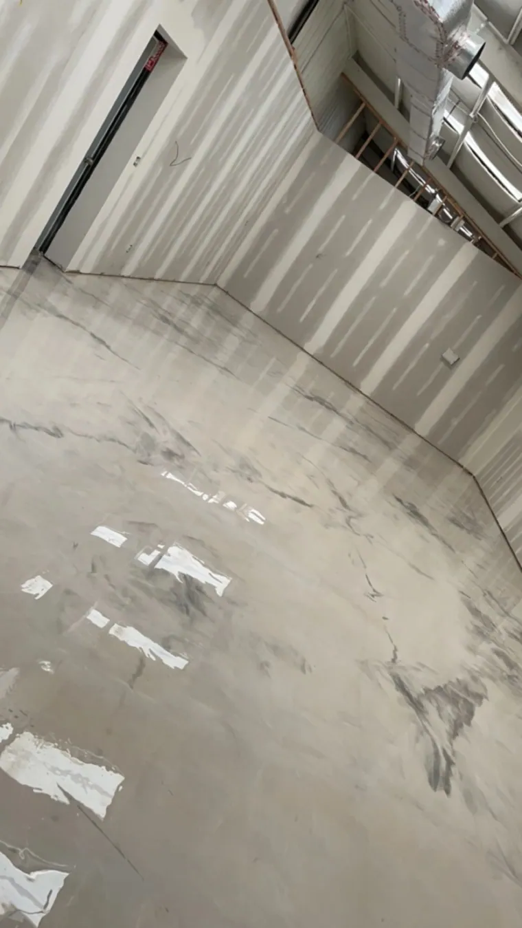 Large open warehouse floor with a polished light-grey finish