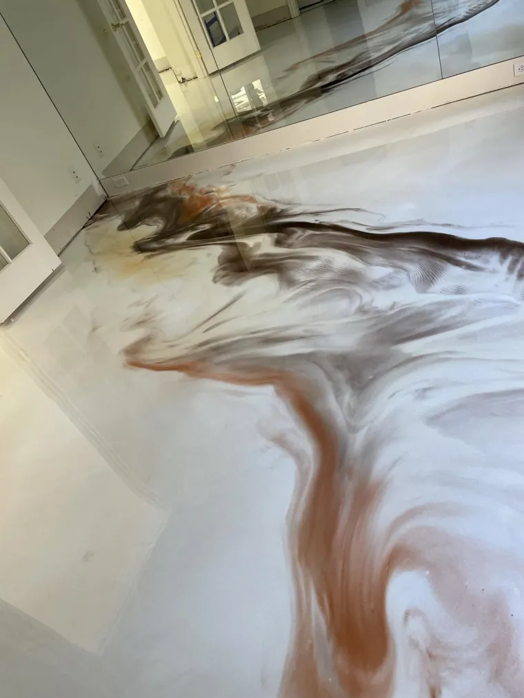 Brown and white metallic epoxy being worked while still wet